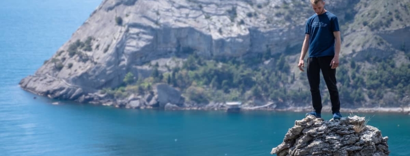 Man balancing atop a towering pillar of rocks, symbolizing the precarious nature and challenges of managing Antisocial Personality Disorder.