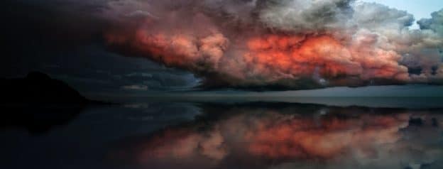 An image depicting the contrasting emotional landscape of BPD, featuring a stormy, tumultuous sky reflecting the inner turmoil, and serene, calm waters below, symbolizing the potential for stability and peace with proper treatment.