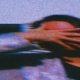 A woman's hand gently covers her face, the image gradually fading into blur, symbolizing the disorientation and confusion often associated with experiencing gaslighting.