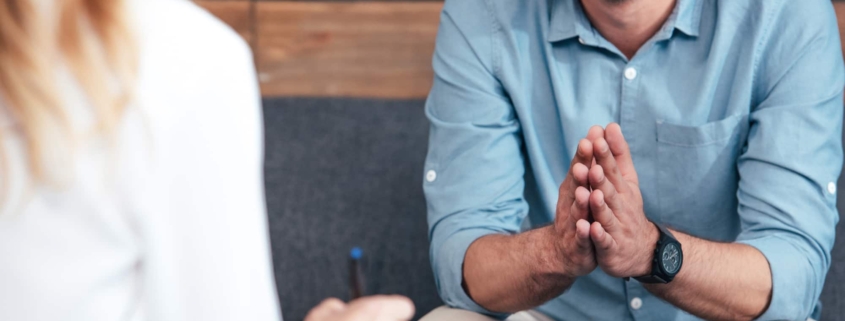 Man engaged in a CBT therapy session, seeking treatment for PTSD, showcasing resilience and hope.