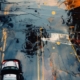 An illustration of a car traveling on a road towards a smudged area, symbolizing the journey through and the unclear nature of retraumatization.