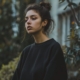 A young woman in a black sweatshirt looks calm after using DBT skills for her emotional regulation.