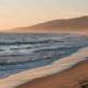 Couple walking along a Southern California beach, symbolizing hope and healing while being in a relationship with someone with PTSD.