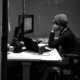 Professional quietly working while experiencing the hidden symptoms of high functioning depression.