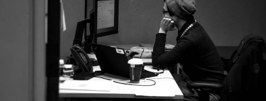 Professional quietly working while experiencing the hidden symptoms of high functioning depression.