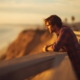 neurodivergent-mental-health-reflection.jpgA young man leans on a railing at sunset, reflecting on neurodivergent mental health.