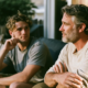 Father and adult son talking on a patio, illustrating family history in an article about whether bipolar disorder is genetic.
